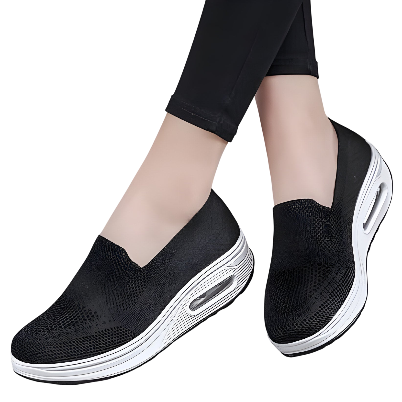 Baskets noires à enfiler, dotées d’une épaisse semelle compensée blanche et d’un coussin d’air.